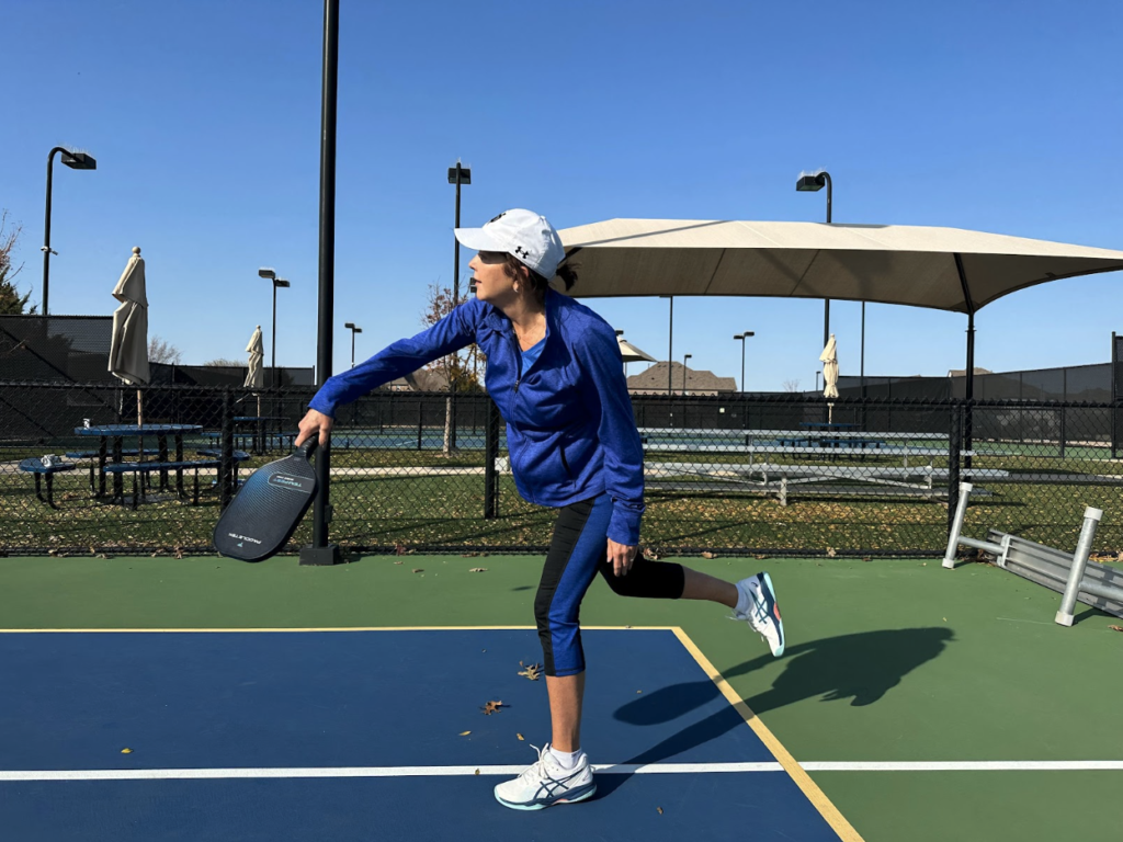 middle aged woman playing pickleball